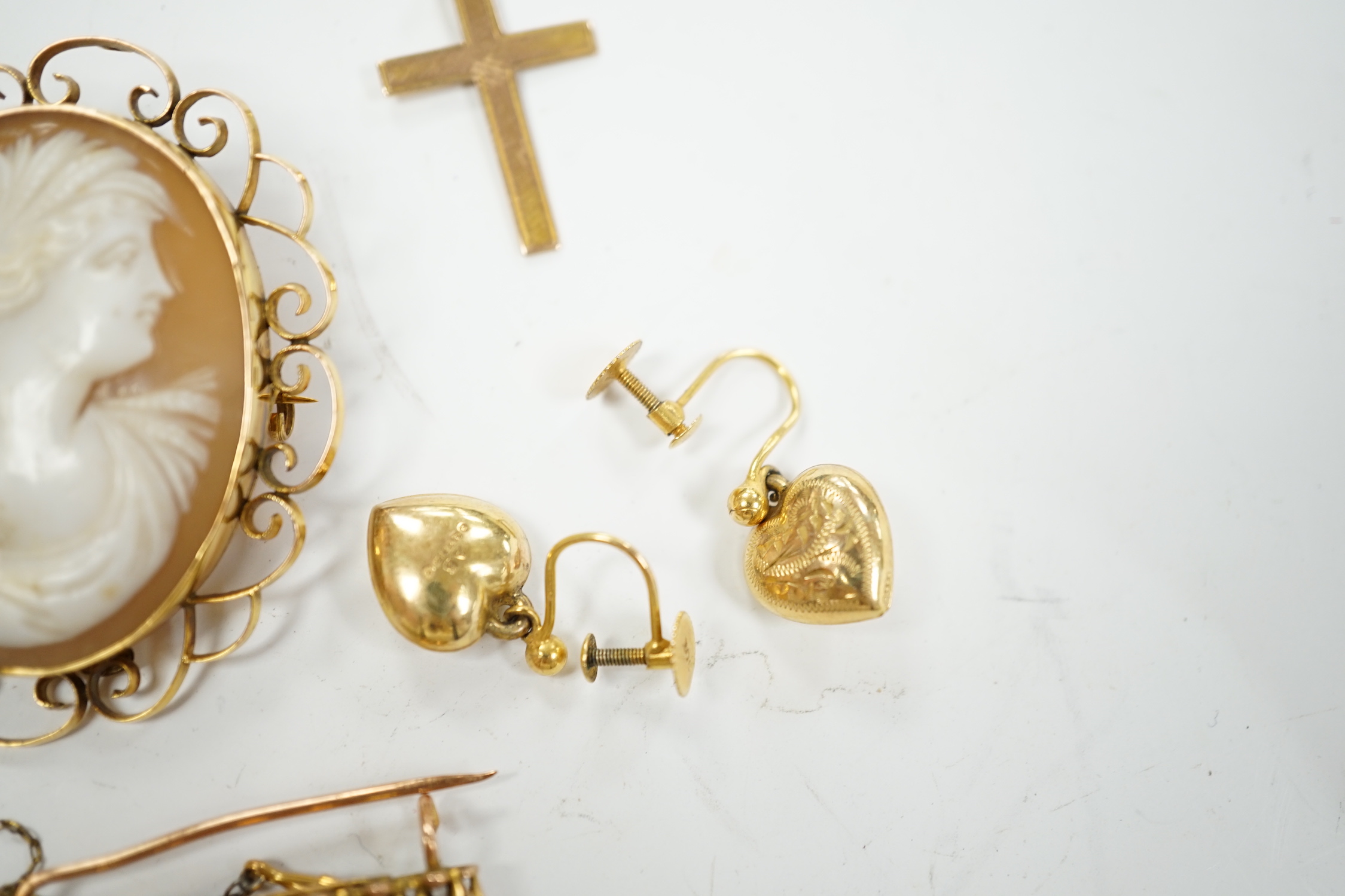 A 9ct and white opal cluster set bar brooch, a 9ct mounted oval cameo shell brooch, a pair of 9ct gold heart shaped drop earrings and a 9ct cross pendant, gross weight 13.4 grams.